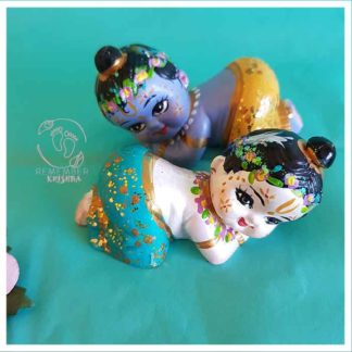Krsna balaram snuggling dolls so cute fit in palm on hand on blue background