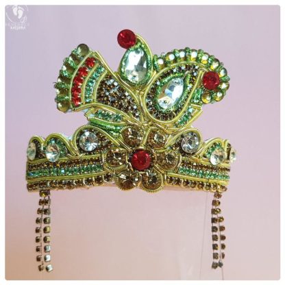 sweet crown for Radha doll or Krishna doll or deities, golden flowers and crystals and red details paisely on a pink background