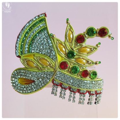 opulent and princely, this crown has the shape of a turban and unique falling fringe of studded gemstones.