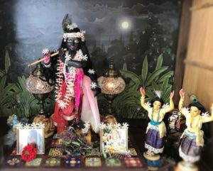 Syamasundar Krishna dark marble krishna in 3 fold bending form playing the flute int he moonlight on this home altar with gaura nitai and a moonlight backdrop