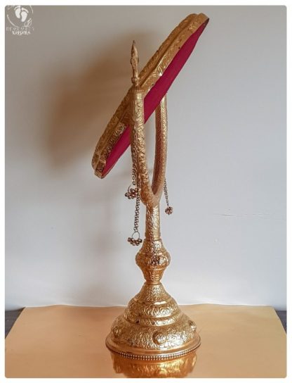 royal gold mirror for deity worship with bell jangles on a stand tilting