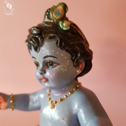 Baby Krishna statue in cradle with red satin sheets and golden pillow with tassels janmastami baby krsna figure