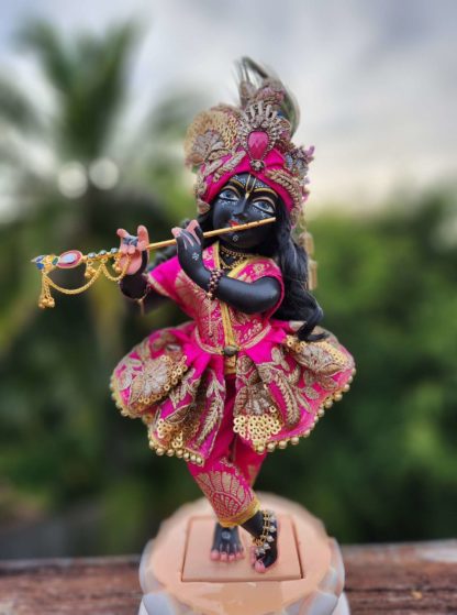 Radha Damodar deity wears gorgeous pink shringar flared skirt. Pink pants and gold embroidery and an opulent pink turban with flowers jewels and cascading details