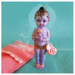 krishna doll for sale pink sleeping bed and turquouise background conchell peacock feather