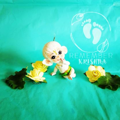 white hanuman doll for sale on blue turquoise background yellow flowers and big eyes cute green dhoti