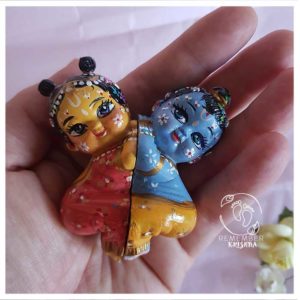 Radha and Krishna nestled together in a heart of love radha krsna. The shape is so sweet. held in palm of hand krsna doll and radha doll make radhe radhe happy