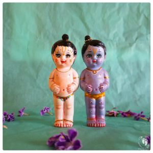 krishna balaram deities with blue and white skin and flower garlands