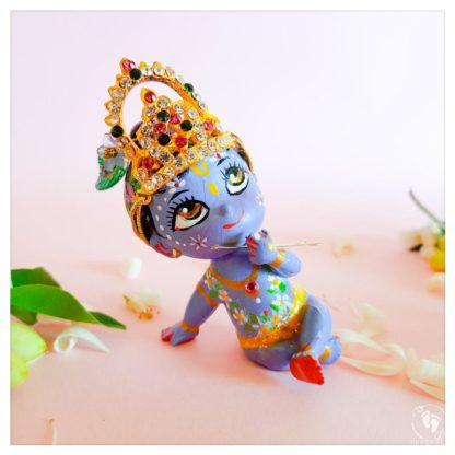 Krishna sitting with a jewelled crown
