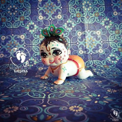 crawling krishna wind up toy with peacock feathers on hands and knees little kahna Krsna