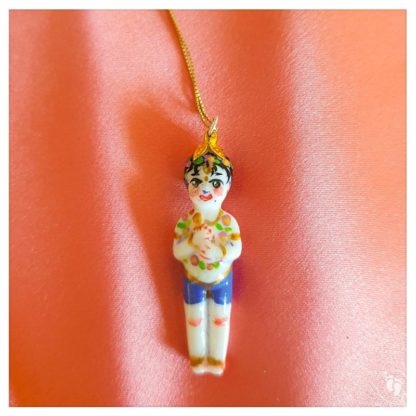 Balaram doll standing pendant on chain and peach background for sale