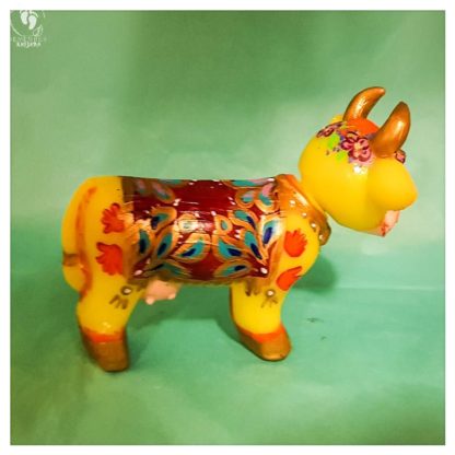 little cow krishnas friend handprints decorated blanket golden horns and flowers friendly face side view