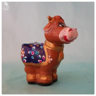 Krsna's cow with blanket and adornments