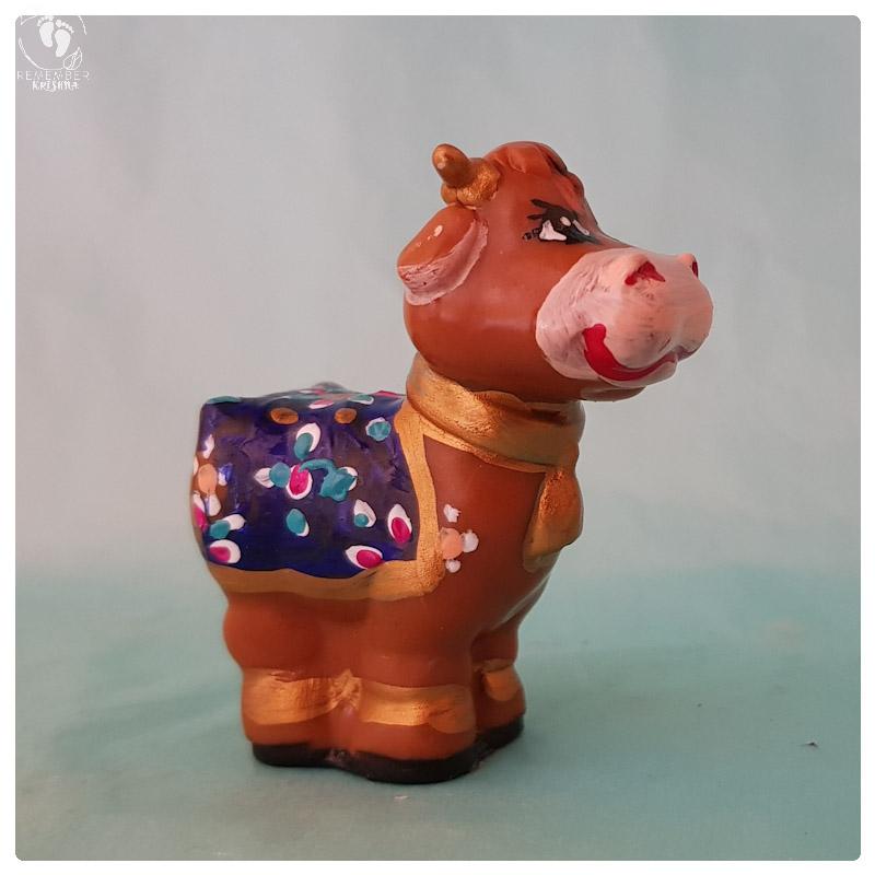 Krsna's cow with blanket and adornments