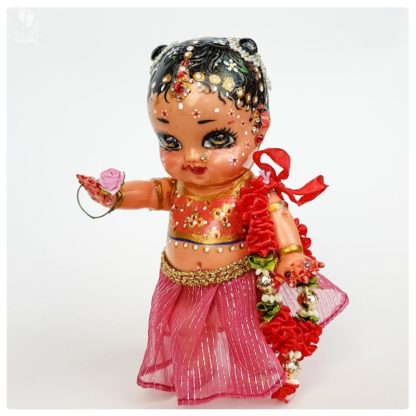 tall radha doll made from plastic with pink clothes and a garland for krsna doll