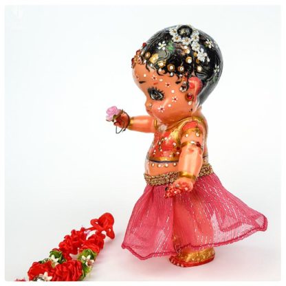 tall radha doll made from plastic with pink clothes and a garland for krsna doll