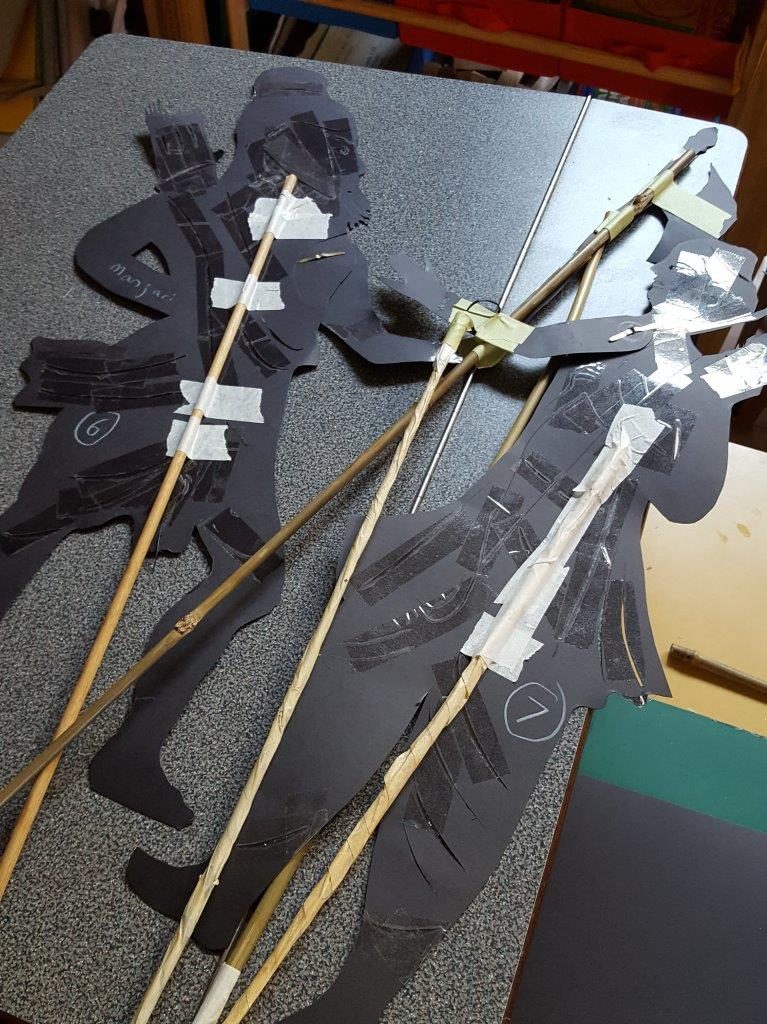 The shadow puppets are cut out of card stock and taped onto long sticks, with moveable joints