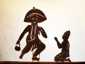 Vamana incarnation of Vishnu shadow puppet silhouette placing foot on Bali Maharaj head