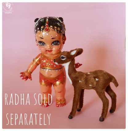 deer and Radha doll standing on pink background cute accessories and krishna's animal friends