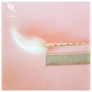 Krishna ornament hindu worship paraphernalia for deity worship, chamara whisk minature fan. Pink background white whisk hair and silver holder, with glitter ruler to show site