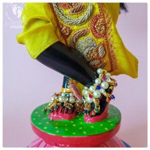 Deity of Krsna standing on lotus flower base wearing pearl anklets
