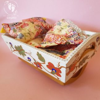 rocking cradle for Krsna dolls painted white ry bedding wooden cradle on pink background