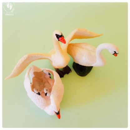 set of three swan dolls toy friends of Krishna plastic swan animals on a aquamarine background