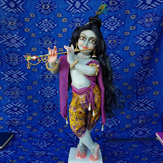 marble deity of krishna blue skin so beautiful with black curling long hair charming outfit
