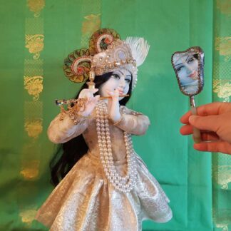 Krishna admires his beautiful reflection in the mirror