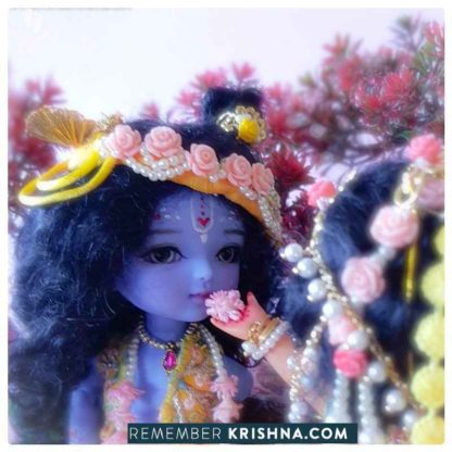 Krishna doll adorable little Krishna standing with sweet smile and levely yellow dhoti vest turban and flower garlands