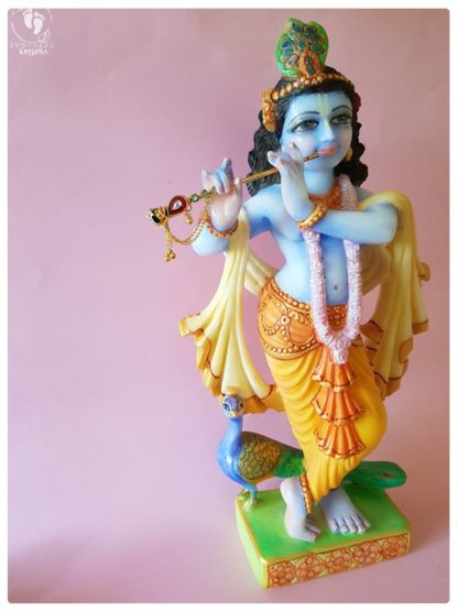 Krishna deity 15 inch white marble side view on pink background