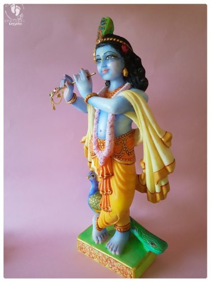 Krishna deity 15 inch white marble side view on pink background