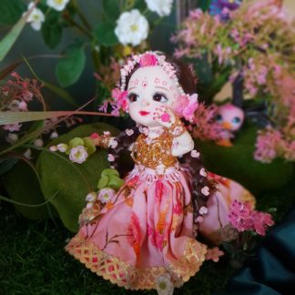 Radha doll poseable standing in a forest glade with flowers and greenery waiting for Shri Krishna to arrive