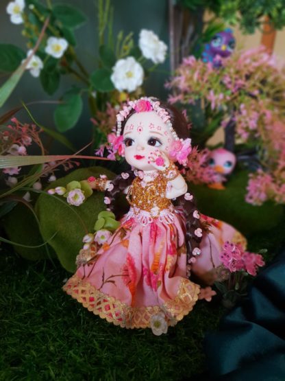 Radha doll poseable standing in a forest glade with flowers and greenery waiting for Shri Krishna to arrive