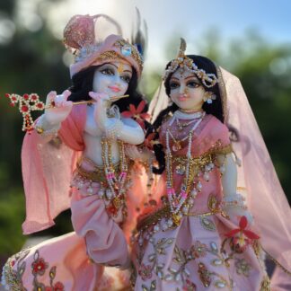 Full shot of Radha and Krishna standing together, highlighting their contrasting outfits and postures.