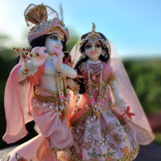 Close-up of Radha's face, showcasing the soft pink shringar and delicate pearls. Alt text: Close-up of Radha's serene face, adorned with a naturally-dyed pink shringar and delicate pearls. (Krishna Radha murti)