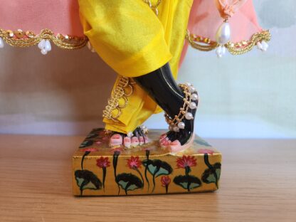 black marble deity of krishna lotus feet and dressed in anklets and dhoti