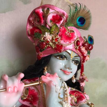murari Krishna deity hand carved marble with delicate grey tinged complexion wearing pink shringar and playing flute