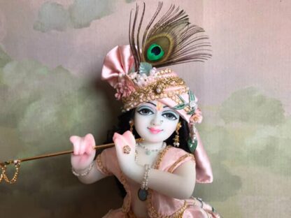 Quality white marble krishna deity hand carved Kamal Nayana weearing soft pink outfit with delicate pink hands in a pink turban and a peacock feather with delicate pearl and gold jewelery 12inch tall deity of Krishna shown holding flute