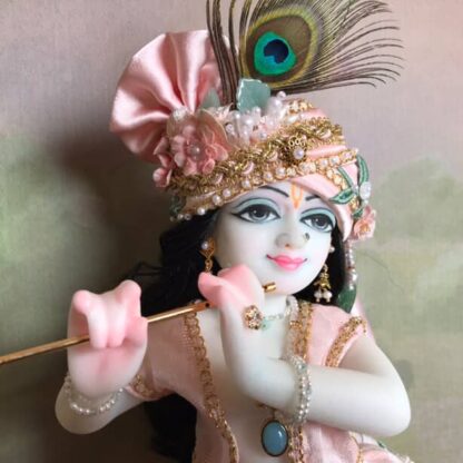 Quality white marble krishna deity hand carved Kamal Nayana weearing soft pink outfit with delicate pink hands in a pink turban and a peacock feather with delicate pearl and gold jewelery 12inch tall deity of Krishna shown holding flute