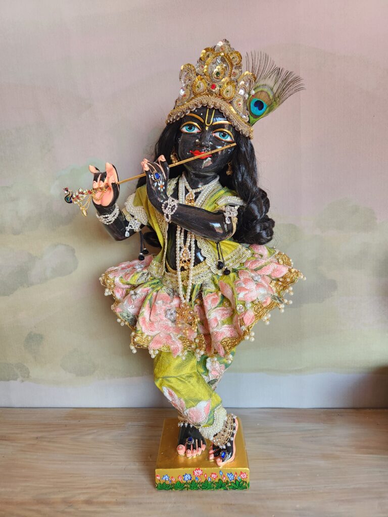 Black Marble Krishna Vigraha 18inch tall dressed in rose pink and green outfit with swirling skirt and golden crown