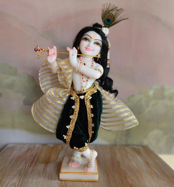 White Marble unique carved and painted deity of Krishna wearing a forest green dhoti with gold and pearl braid and a sheer shawl belted at the waist, ornamented with gold stripes