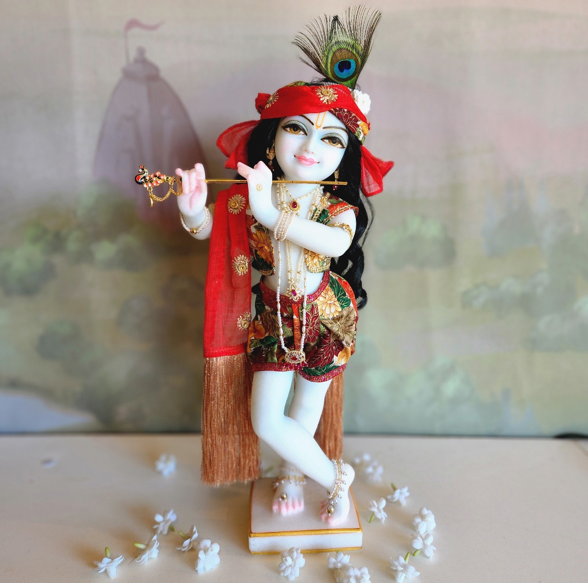 marble deity of krishna painted a soft delicate blue hue autumn leaves