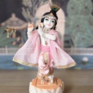 balgopal deity of krishna carved in white marble with a lotus base. dressed in delicate pink shringar