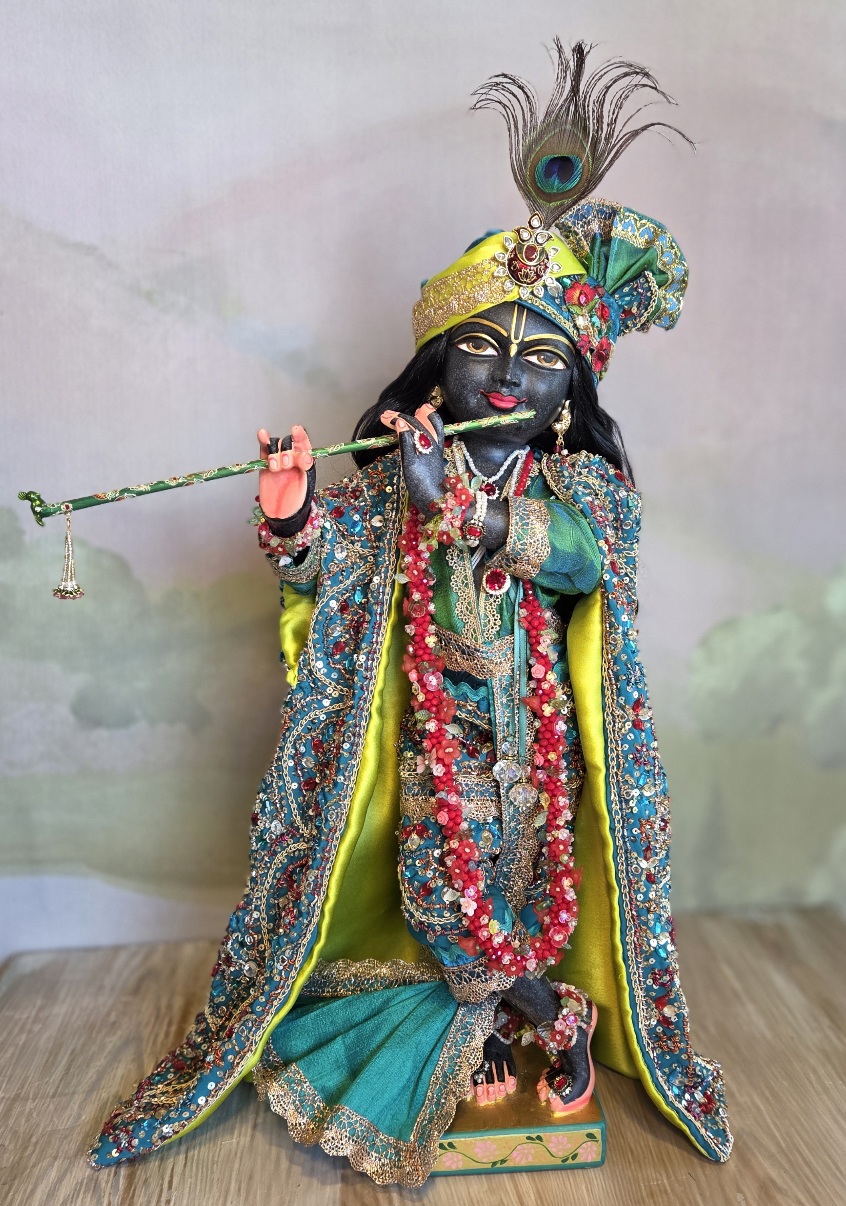 Luxurious black Marble deity of Gopinath Krishna standing with flute to His nectarian lips. Gopinath a hand-carved black marble Krishna deity, 18 inches tall, with 7 outfits & flower-jewel shringar included. One of a kind — free shipping. Dressed in citrine yellow and kingfisher blue green with garlands of everfresh flowers and pearl jewelery