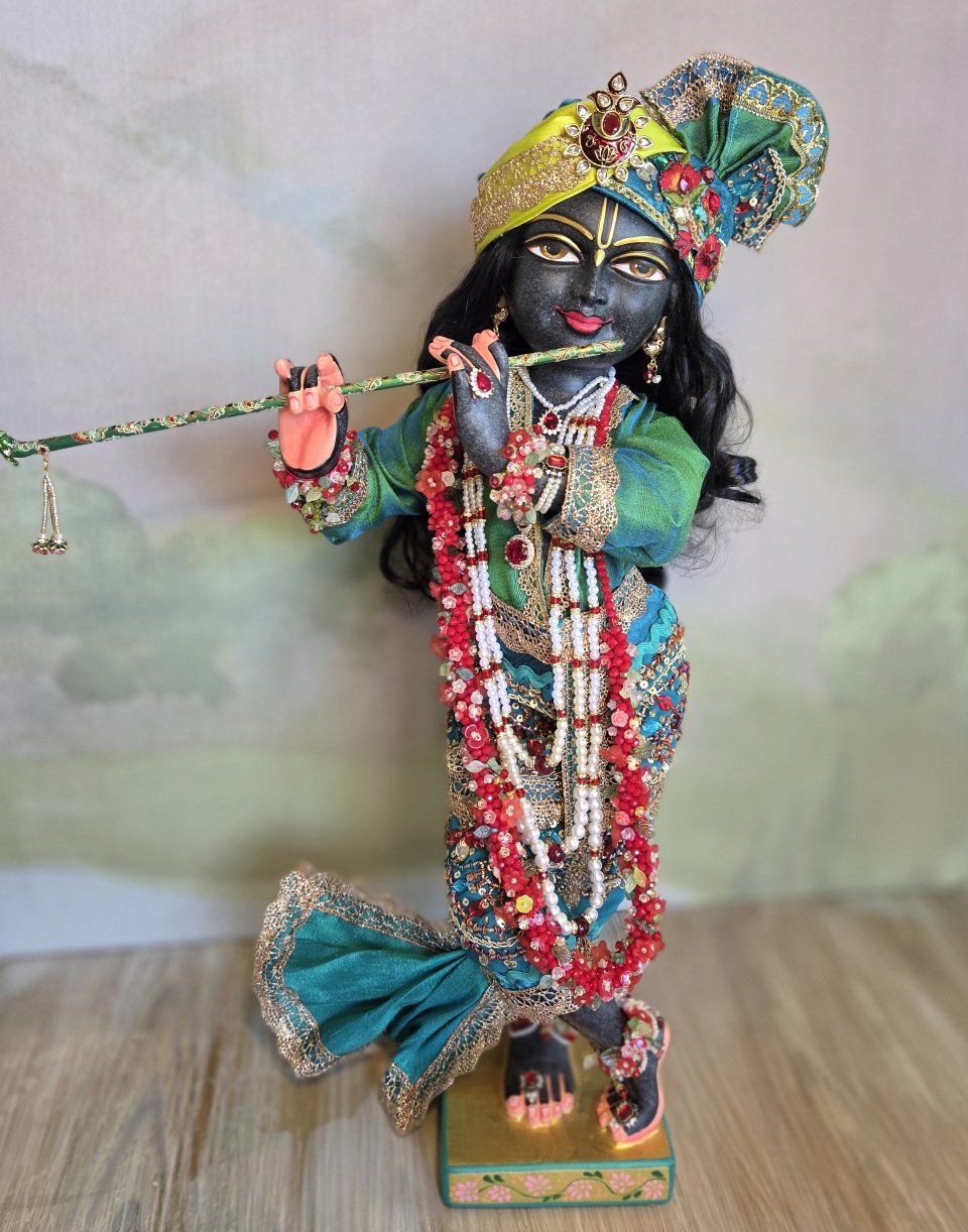 Luxurious black Marble deity of Gopinath Krishna standing with flute to His nectarian lips. Gopinath a hand-carved black marble Krishna deity, 18 inches tall, with 7 outfits & flower-jewel shringar included. One of a kind — free shipping. Dressed in citrine yellow and kingfisher blue green with garlands of everfresh flowers and pearl jewelery