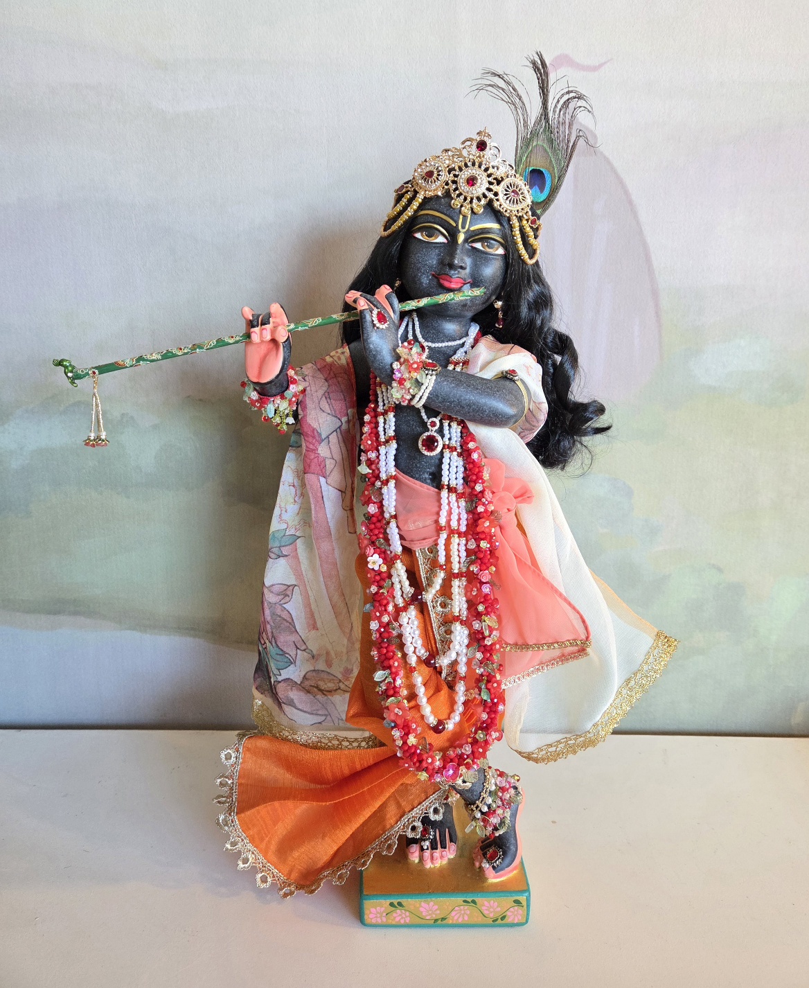 Gopinatha a black marble Krishna deity of 18inch height. Dressed in a gorgeous orange dhoti with a full length delicate shawl, ornamented with jewellery and a golden crown the deity form holds a bamboo flute and wears a peacock feather in His hair